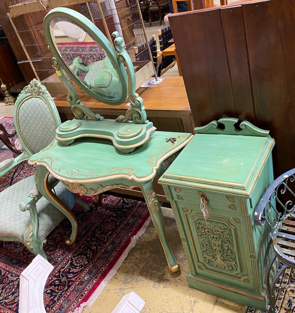 A Victorian style mahogany open armchair, together with a side table, dressing mirror and bedside cupboard, all painted green